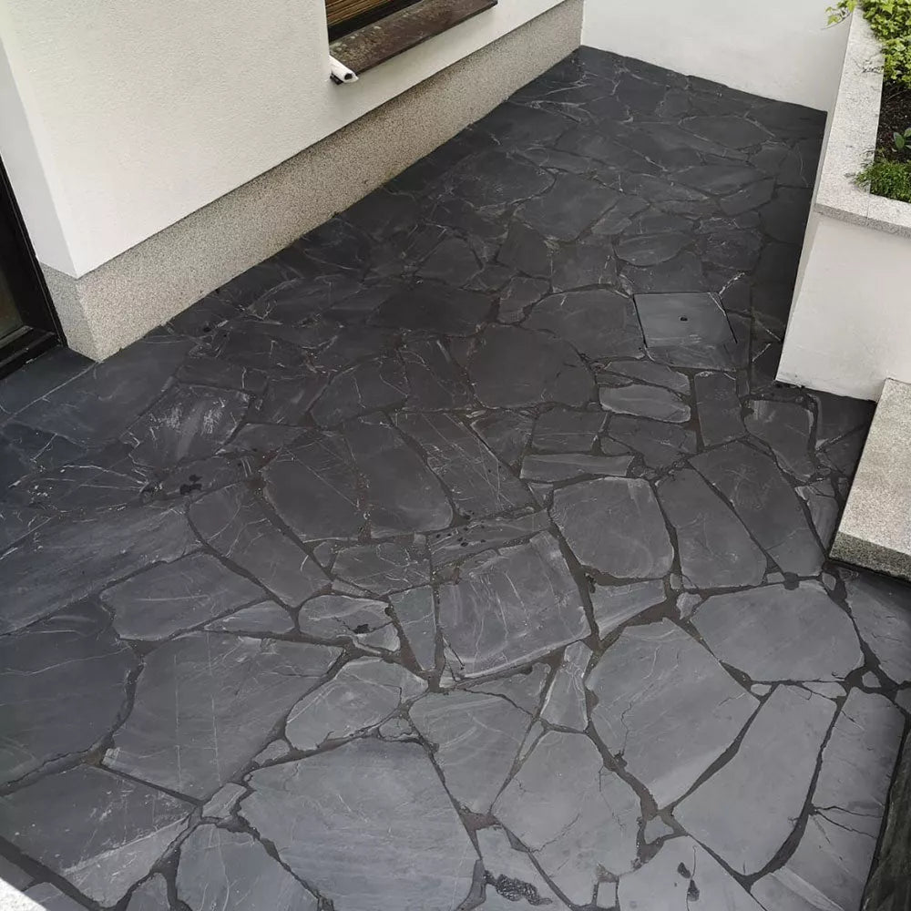 A patio of Negra slate natural stone slabs